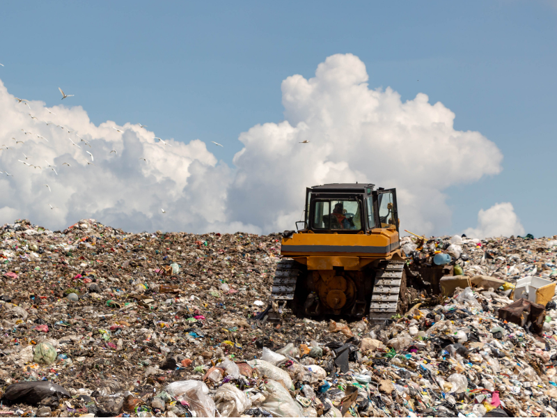 Bulldozer operating on a large landfill site